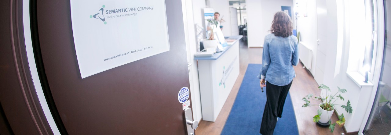 Person entering an office corridor